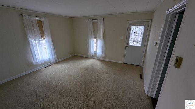 401 S 5th St, Deepwater, MO 64740 - foyer entrance with carpet, visible vents, baseboards, and ornamental molding