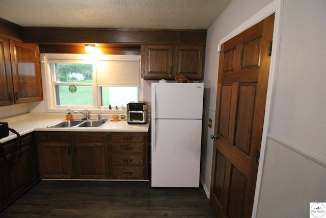 101 Lakeveiw Dr, Windsor, MO 65360 - kitchen with freestanding refrigerator, a sink, light countertops, dark wood finished floors, and a textured ceiling