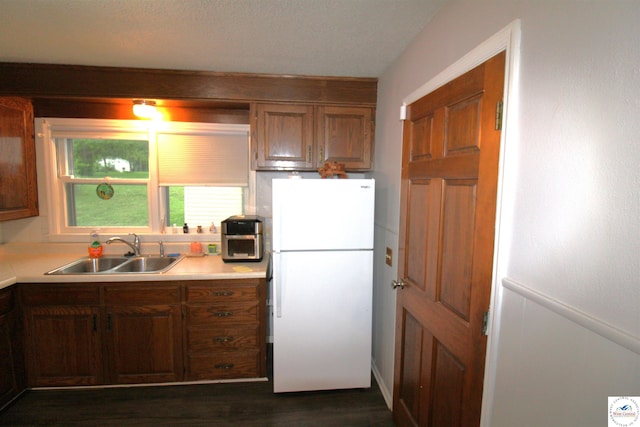 101 Lakeveiw Dr, Windsor, MO 65360 - kitchen with freestanding refrigerator, a sink, light countertops, and dark wood finished floors