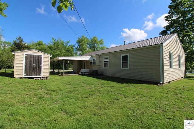 101 Lakeveiw Dr, Windsor, MO 65360 - rear view of property with a yard, cooling unit, and metal roof