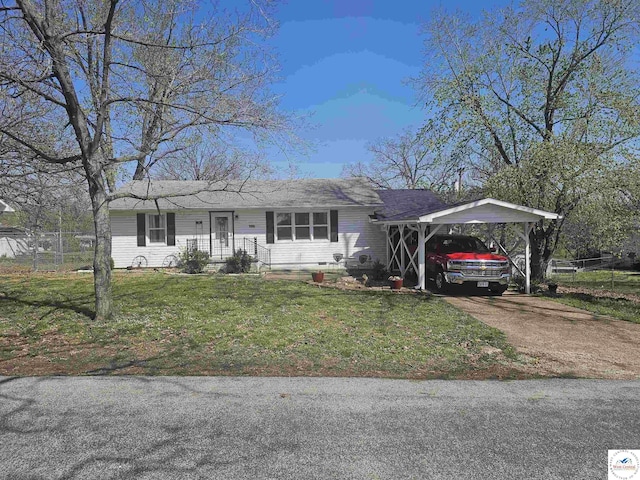 ranch-style house featuring driveway, a front yard, and an attached carport