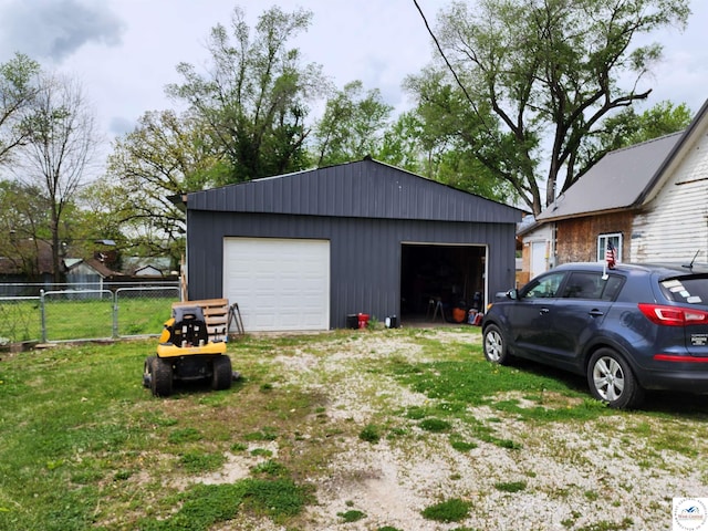 detached garage featuring fence