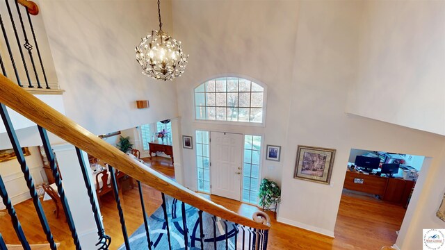 1519 Cobblestone Dr, Sedalia, MO 65301 - entrance foyer with a chandelier, baseboards, wood finished floors, and a towering ceiling