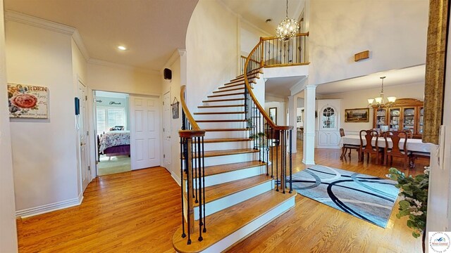 1519 Cobblestone Dr, Sedalia, MO 65301 - stairway featuring baseboards, ornamental molding, an inviting chandelier, and wood finished floors
