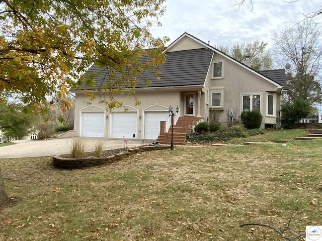 1519 Cobblestone Dr, Sedalia, MO 65301 - view of front of property with stucco siding, driveway, a front yard, and a garage