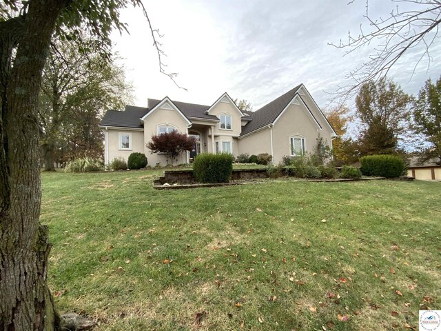 1519 Cobblestone Dr, Sedalia, MO 65301 - view of front of property with stucco siding and a front yard