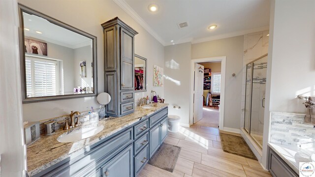 1519 Cobblestone Dr, Sedalia, MO 65301 - bathroom with a sink, double vanity, a stall shower, ornamental molding, and a spacious closet