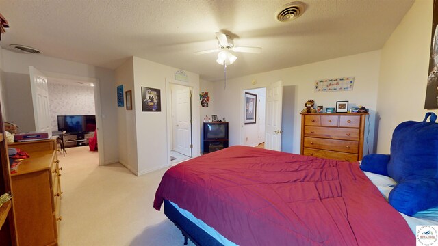 1519 Cobblestone Dr, Sedalia, MO 65301 - bedroom with a ceiling fan, visible vents, light carpet, and a textured ceiling