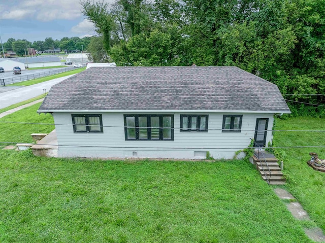 245 Randolph St, Tipton, MO 65081 - view of front of house with a front lawn, a shingled roof, and fence