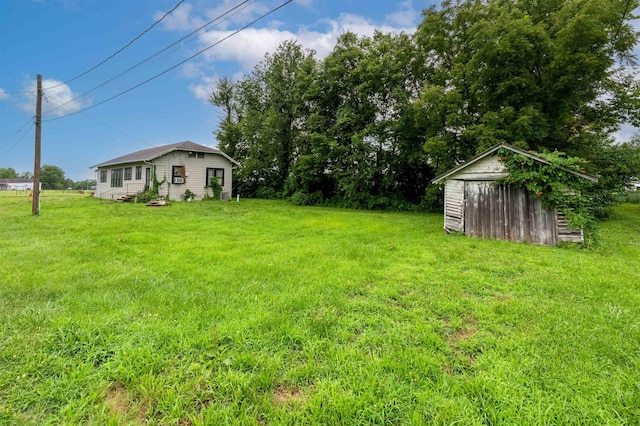 245 Randolph St, Tipton, MO 65081 - view of yard with a shed and an outbuilding