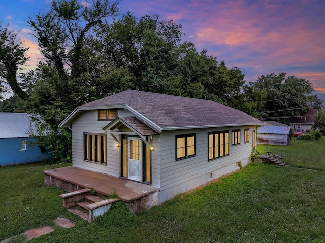 245 Randolph St, Tipton, MO 65081 - view of front facade with a shingled roof and a yard