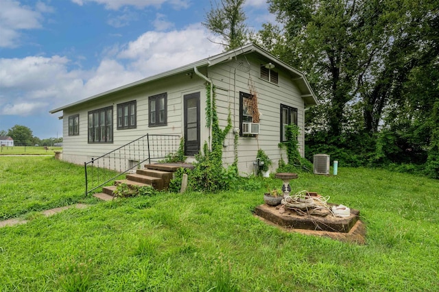 245 Randolph St, Tipton, MO 65081 - exterior space featuring central air condition unit, cooling unit, and a front yard