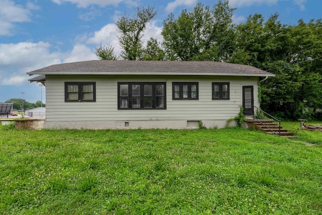 245 Randolph St, Tipton, MO 65081 - rear view of property with a lawn and roof with shingles