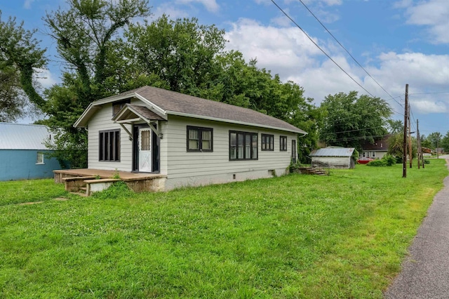 245 Randolph St, Tipton, MO 65081 - view of front of home with a shingled roof and a front lawn