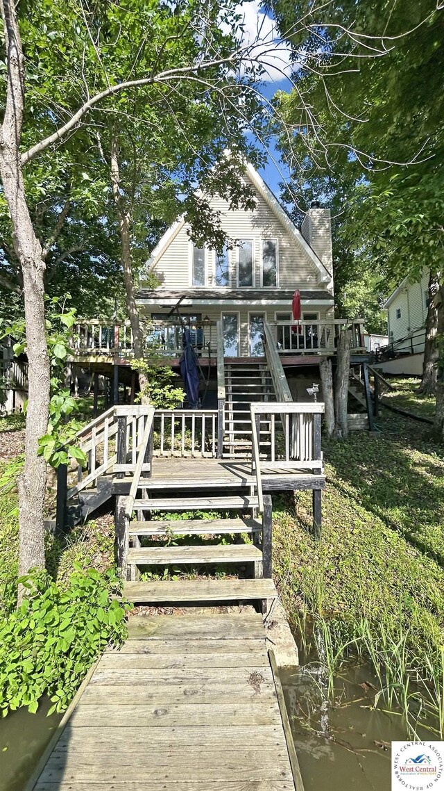 28801 Herbs Rd, Lincoln, MO 65338 - view of front of home with stairway, a chimney, and a deck