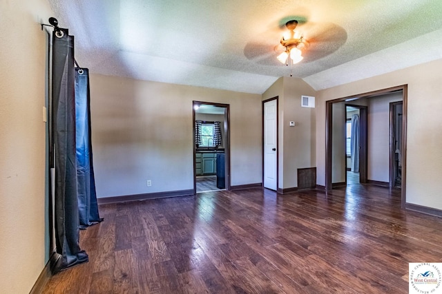 806 E Green St, Clinton, MO 64735 - spare room with wood finished floors, a ceiling fan, lofted ceiling, baseboards, and a textured ceiling