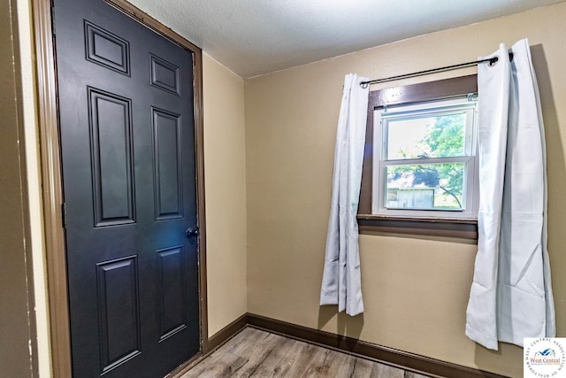 806 E Green St, Clinton, MO 64735 - doorway to outside featuring wood finished floors and baseboards
