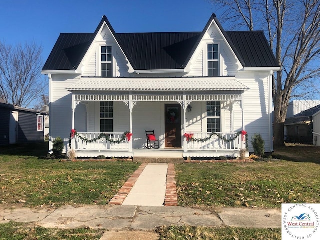 202 N Maple St, Stover, MO 65078 - view of front of home featuring a porch, a front yard, and metal roof