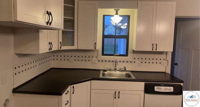 202 N Maple St, Stover, MO 65078 - kitchen with dishwashing machine, a sink, dark countertops, white cabinetry, and glass insert cabinets