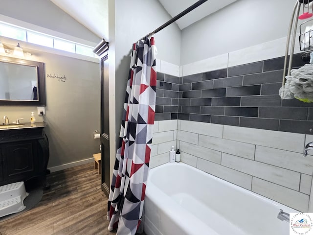 202 N Maple St, Stover, MO 65078 - full bath featuring wood finished floors, shower / tub combo with curtain, vanity, vaulted ceiling, and baseboards