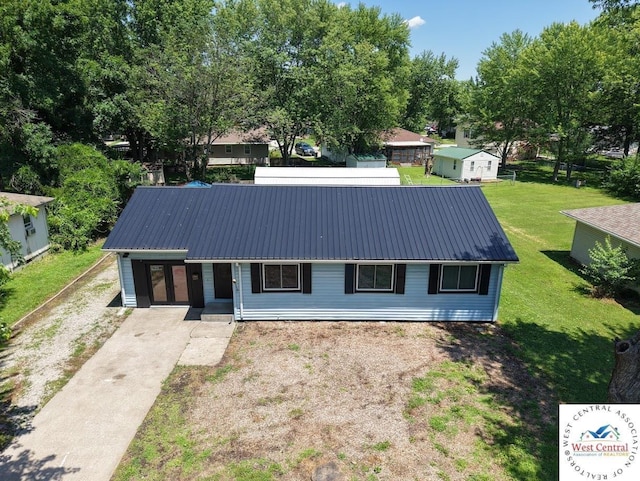 2704 Rosebud Cir, Sedalia, MO 65301 - view of front of house with a metal roof, a front lawn, and concrete driveway