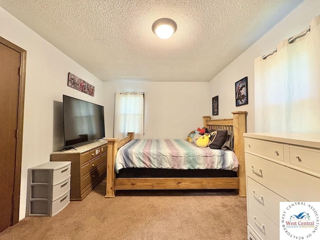 2704 Rosebud Cir, Sedalia, MO 65301 - bedroom featuring light carpet and a textured ceiling