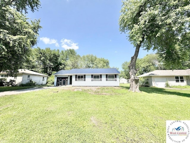 2704 Rosebud Cir, Sedalia, MO 65301 - ranch-style home with a front lawn, driveway, a metal roof, and an attached garage