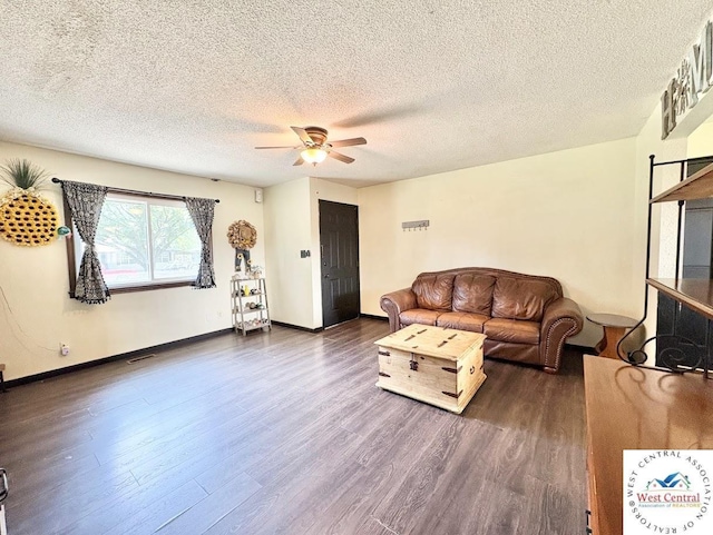 2704 Rosebud Cir, Sedalia, MO 65301 - living area featuring dark wood-style floors, ceiling fan, and a textured ceiling