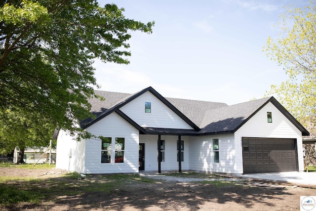 1927 E 6th St, Sedalia, MO 65301 - modern farmhouse style home with a garage, concrete driveway, and a shingled roof