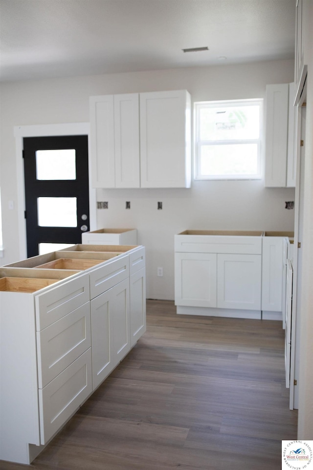 1927 E 6th St, Sedalia, MO 65301 - kitchen featuring white cabinetry and wood finished floors