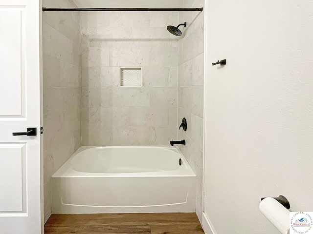 bathroom with bathing tub / shower combination and wood finished floors