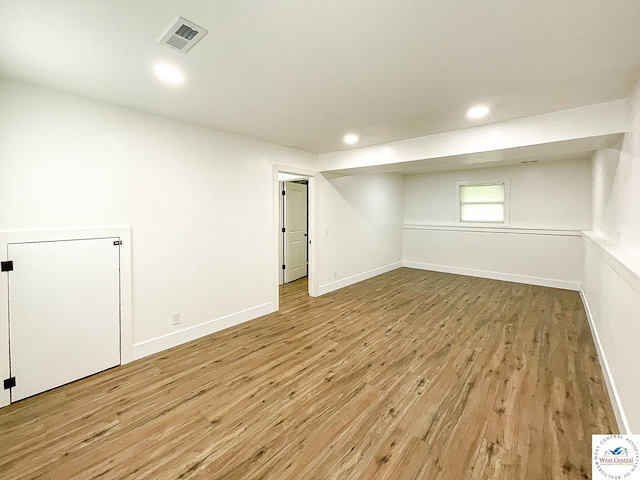 basement featuring visible vents, recessed lighting, baseboards, and light wood-type flooring
