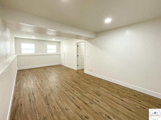 below grade area with baseboards, recessed lighting, and wood finished floors