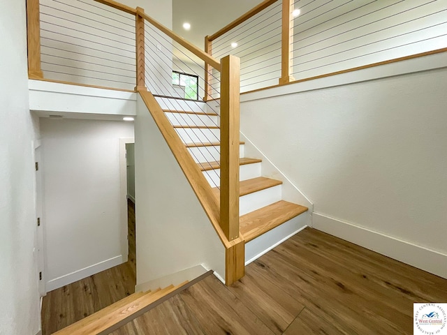 stairs featuring baseboards, recessed lighting, and wood finished floors