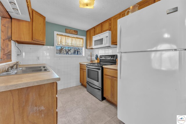 25939 Old Oar House Rd, Warsaw, MO 65355 - kitchen with white appliances, light tile patterned floors, light countertops, tasteful backsplash, and brown cabinets