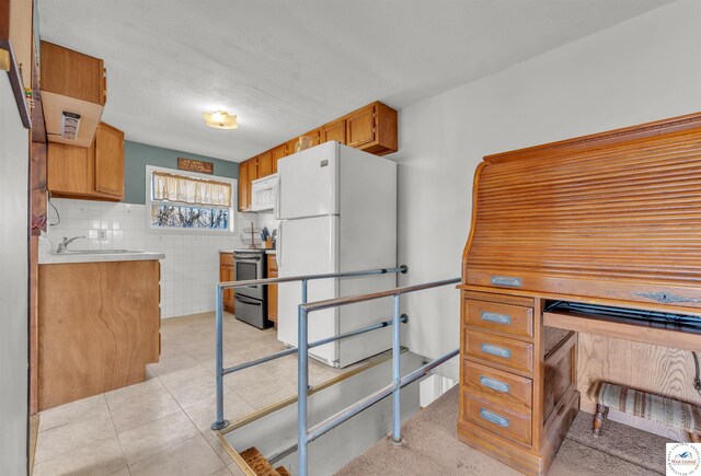 25939 Old Oar House Rd, Warsaw, MO 65355 - kitchen featuring white appliances, light countertops, brown cabinetry, and light tile patterned flooring