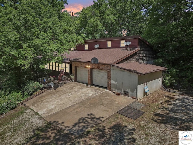 828 SE 601st Rd, Leeton, MO 64761 - view of front of property featuring roof with shingles, a garage, and driveway