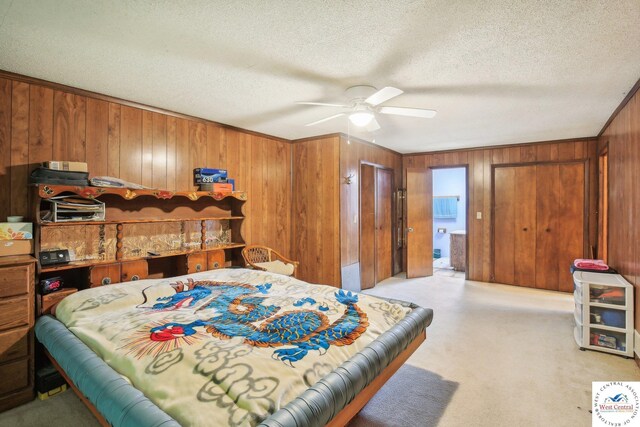 828 SE 601st Rd, Leeton, MO 64761 - bedroom featuring wooden walls, light colored carpet, a textured ceiling, and ceiling fan