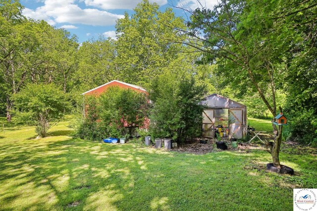 828 SE 601st Rd, Leeton, MO 64761 - view of green lawn featuring an exterior structure and an outbuilding