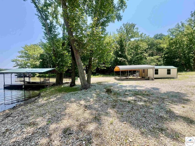 31674 Aspen Rd, Stover, MO 65078 - view of yard with a detached carport and a boat dock