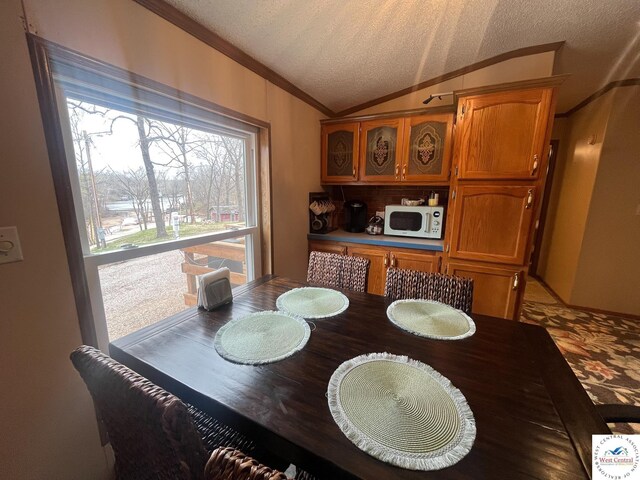 31674 Aspen Rd, Stover, MO 65078 - dining room with ornamental molding, a textured ceiling, and lofted ceiling