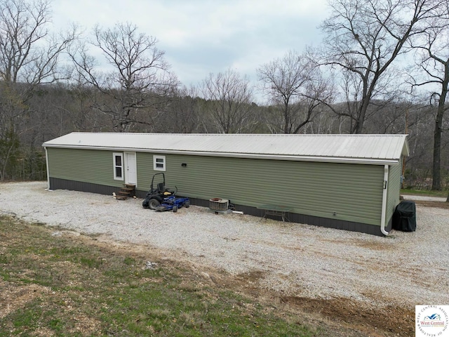 31674 Aspen Rd, Stover, MO 65078 - rear view of property featuring entry steps and a metal roof