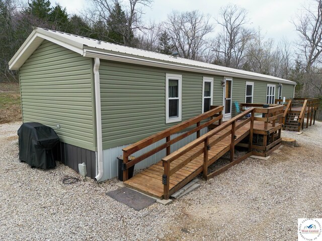 31674 Aspen Rd, Stover, MO 65078 - view of front of home with a wooden deck and a metal roof