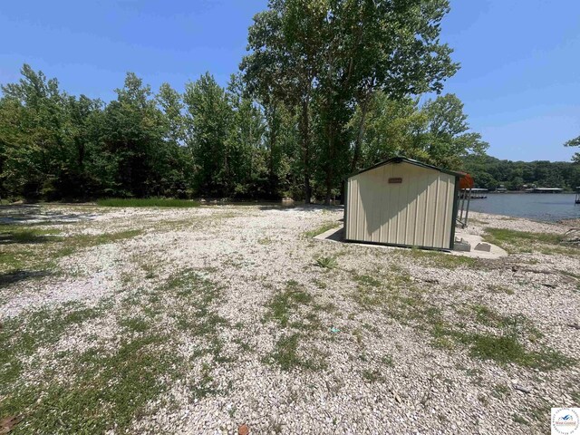 31674 Aspen Rd, Stover, MO 65078 - view of yard featuring a storage shed and a water view
