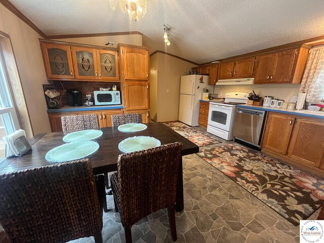 31674 Aspen Rd, Stover, MO 65078 - kitchen featuring white appliances, crown molding, under cabinet range hood, stone finish flooring, and a textured ceiling