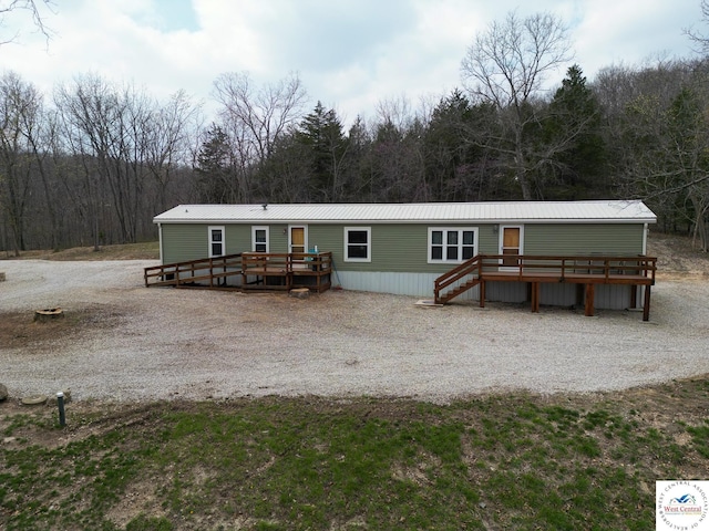 31674 Aspen Rd, Stover, MO 65078 - manufactured / mobile home with a wooden deck, a view of trees, a metal roof, and stairway