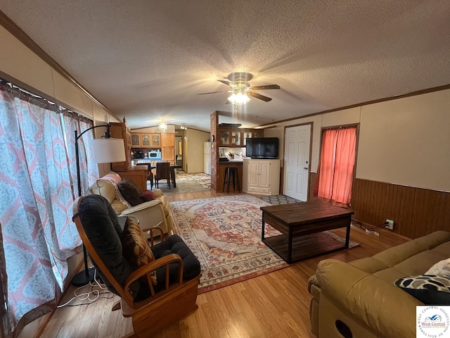 31674 Aspen Rd, Stover, MO 65078 - living room with ornamental molding, wainscoting, ceiling fan, a textured ceiling, and light wood-type flooring