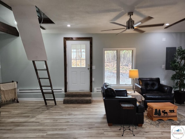 10075 Otter Rd, Clinton, MO 64735 - living room with a baseboard heating unit, ceiling fan, wood finished floors, baseboards, and recessed lighting