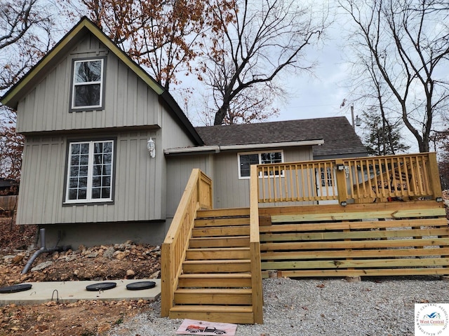 10075 Otter Rd, Clinton, MO 64735 - view of front facade featuring roof with shingles, stairs, and a wooden deck