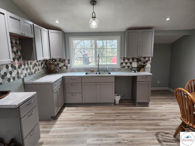 10075 Otter Rd, Clinton, MO 64735 - kitchen with a sink, gray cabinets, light wood-style floors, decorative backsplash, and recessed lighting